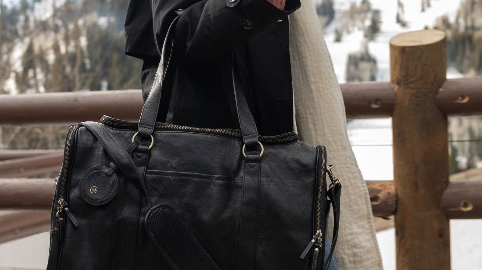 Model walking with black AZARIA madeleine weekender bag