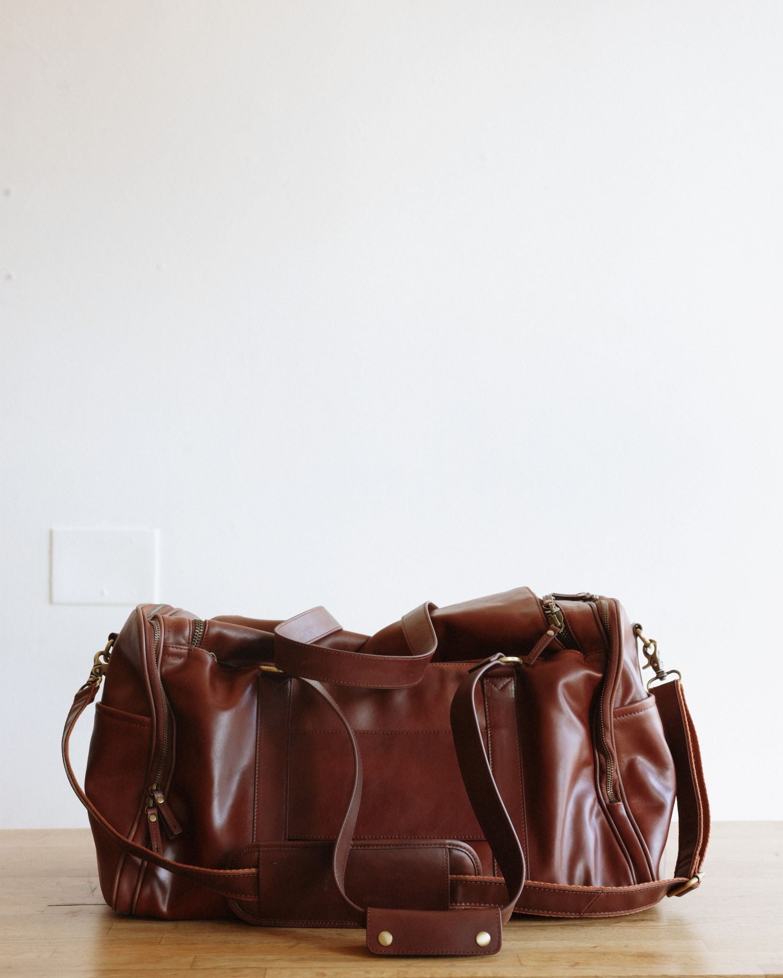 Luxe Leather Weekender Bag in Cognac on table
