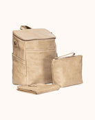 Beige leather backpack, pouch, and blanket set on a white background